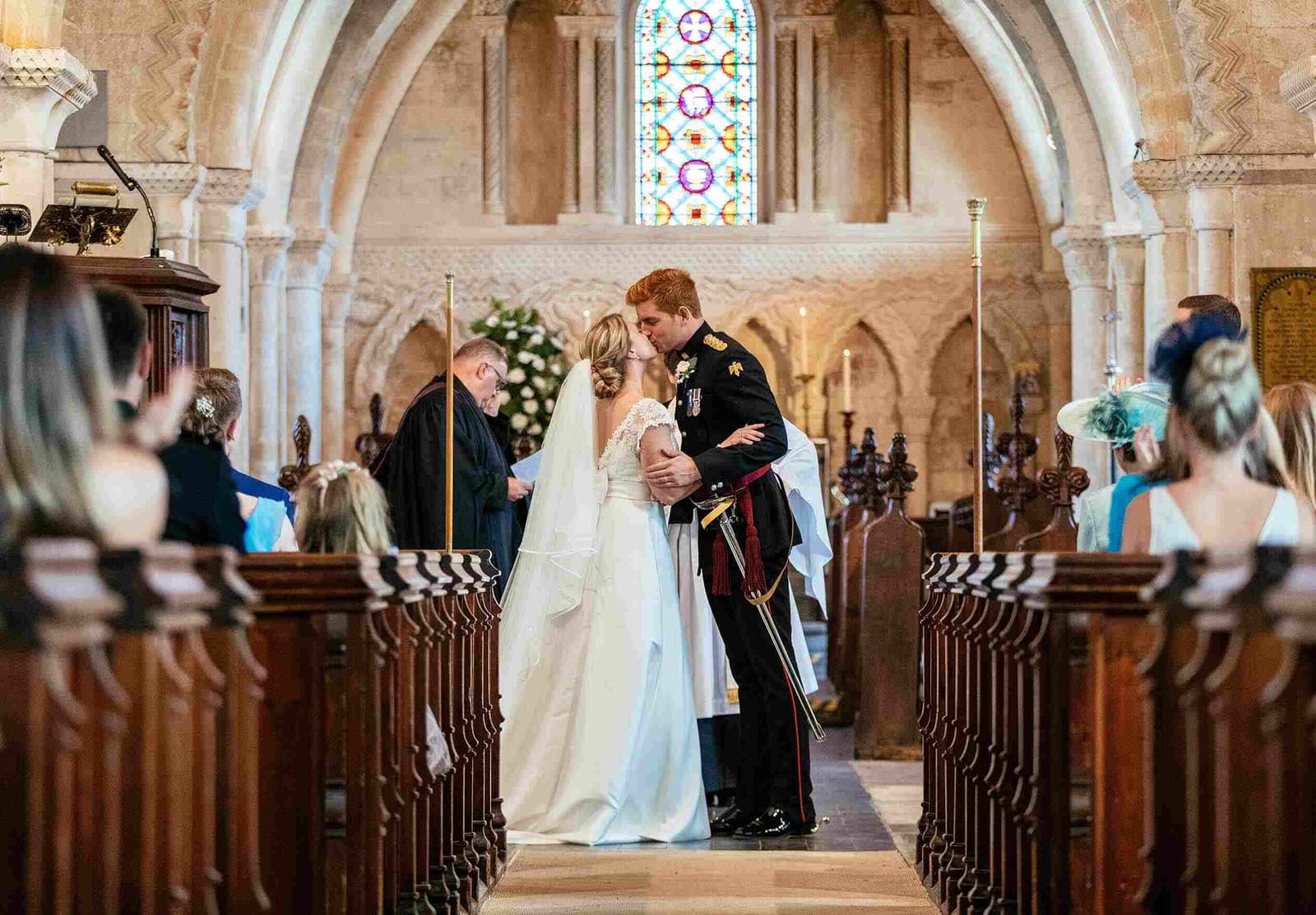 Husband and wife kissing at the altar