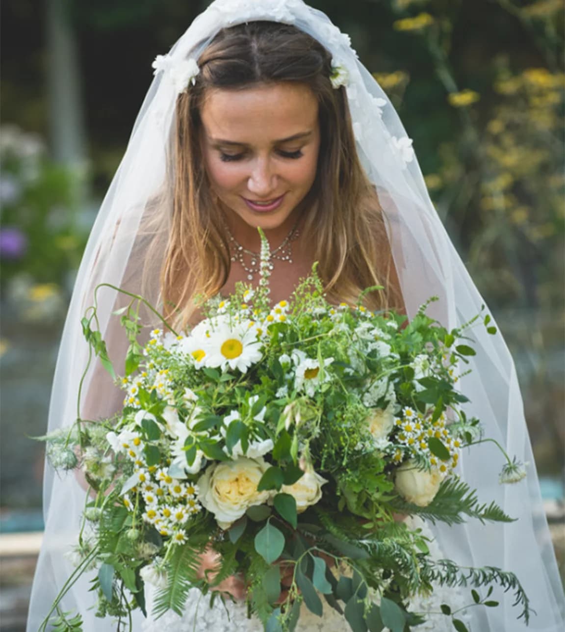Bride holds her wedding bouquet created by Carrie Macey