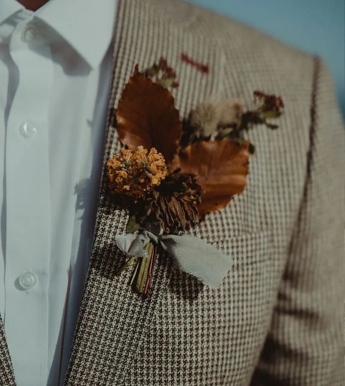 Stylish autumn flowers in groom's jacket buttonhole