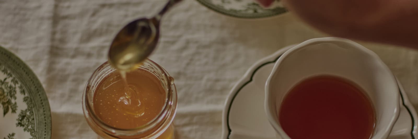 Cup of tea and honey on table 